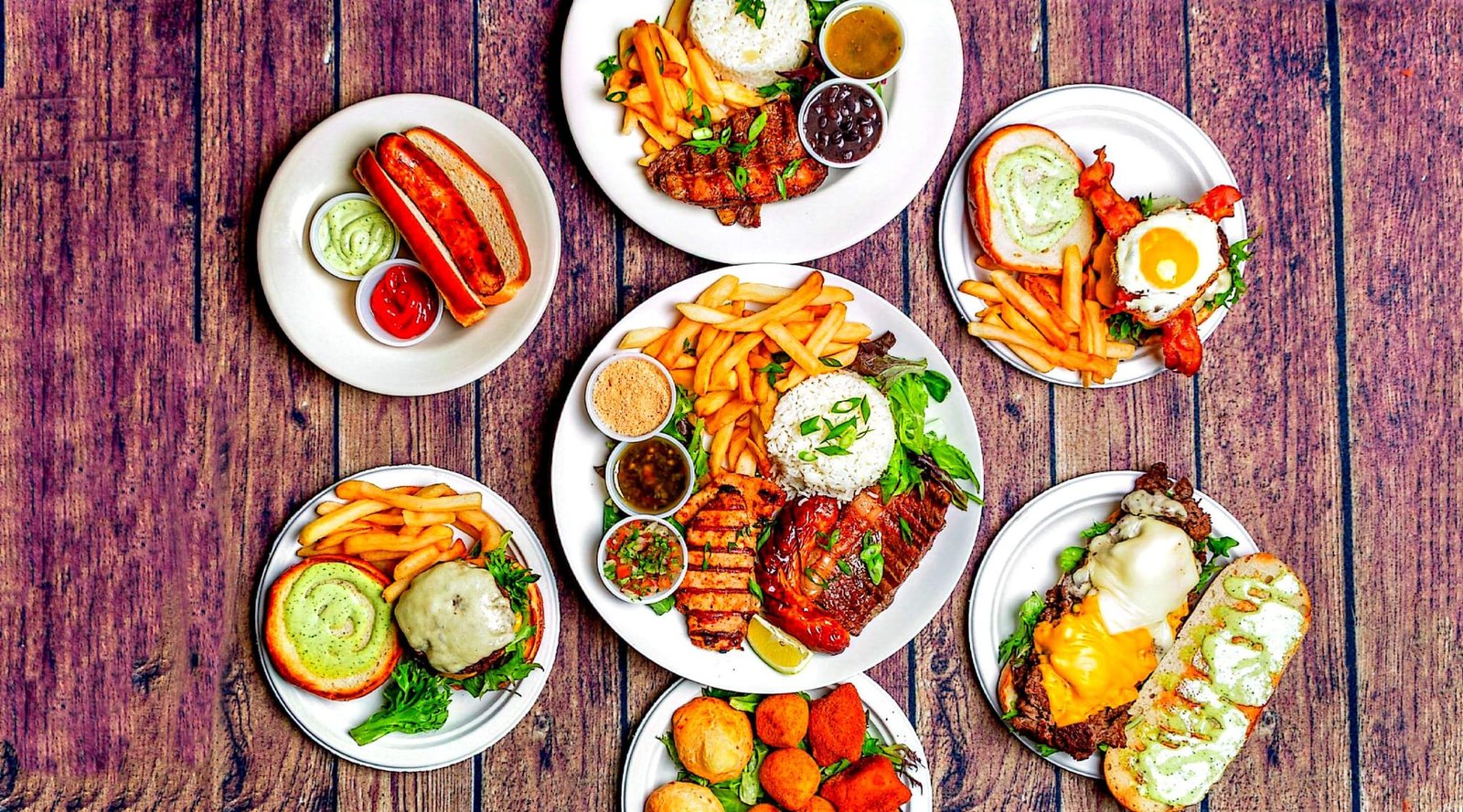 A table spread with Eduardo's grilled plates, sides, and Brazilian favorites
