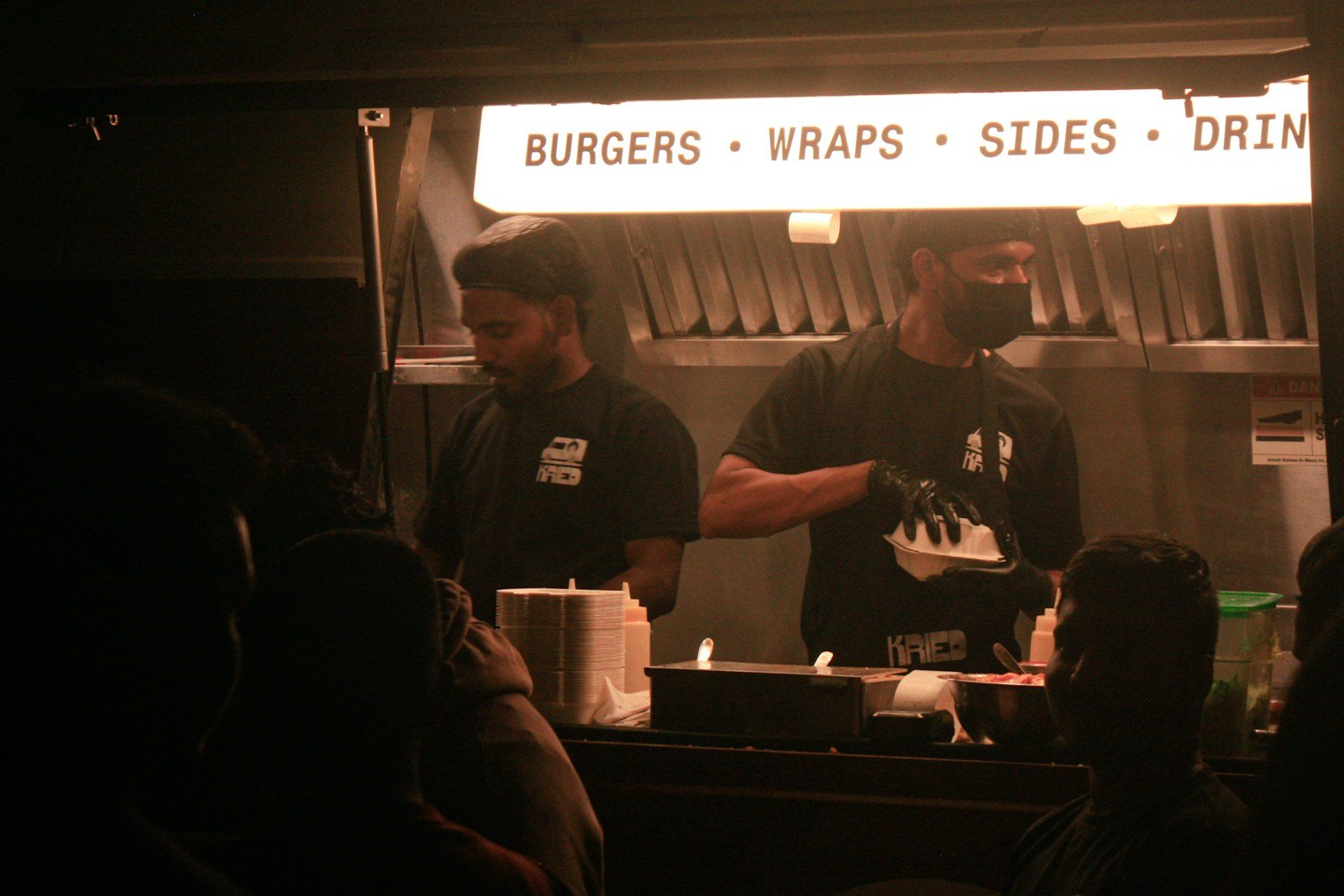 A food truck team serving guests at the service window
